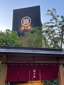 a building with a sign on the top of it at Hotel Fukudaya in Tokyo