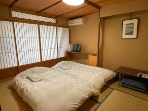Tempat tidur dalam kamar di Hotel Fukudaya