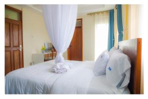 מיטה או מיטות בחדר ב-Nataaha Hotels