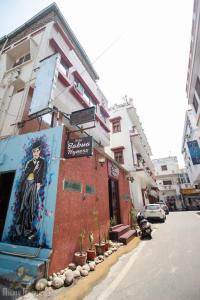 a building with a painting on the side of it at Hotel Babua Hyness By Avadhesh Group Of Hospitality in Haridwār