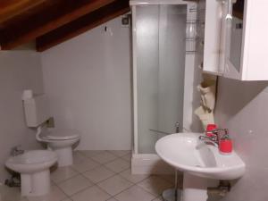 a bathroom with two toilets and a sink and a shower at appartamento signorile con giardino CIR 0097 in Aosta