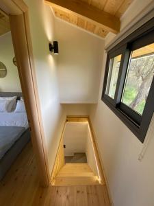 a small room with a bed and a window at Olive Tree Apartments in Lefkada Town