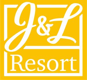 a yellow sign with the name of a resort at J&L Resort in Willemstad