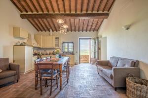 eine Küche und ein Wohnzimmer mit einem Tisch und Stühlen in der Unterkunft Torre di Corsanello in Monteroni dʼArbia