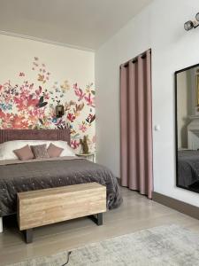 a bedroom with a bed and a large mirror at Apartment- La Rochelle historic city centre in La Rochelle