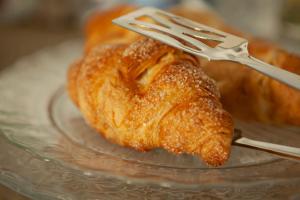 a fork holding a piece of food on a glass plate at Locanda San Bernardo in Vigevano +52 photos