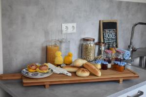 a cutting board with bread and food on a counter at BenB de Walvis in Krimpen aan de Lek