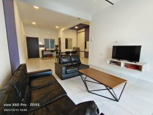 a living room with a couch and a table at ICOLOR HOME & STAY CH4 in Tanah Rata