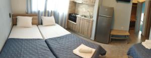 a small room with two beds and a kitchen at STUDIOS KOULA 2-DIMOS in Potos