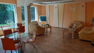 a living room with couches and chairs and a table at Motivi Hotel in St. St. Constantine and Helena