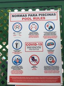 a sign for the nonhuman parana persons pool rules at LA CAMPANA in Orihuela Costa