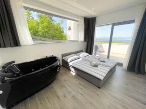 a bedroom with a bed and a bath tub at Villa Linda in Crikvenica +70 photos