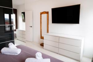 Televízia a/alebo spoločenská miestnosť v ubytovaní Apartamento Arkadio