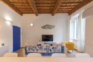 a living room with a bed and a couch and chairs at HelloElba Appartamento Mascalzone Latino in Portoferraio