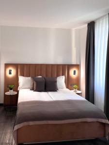 Postel nebo postele na pokoji v ubytování Bayer's City Hotel