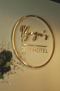 a sign for a city hotel on a wall at Bayer's City Hotel in Munich