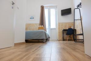 A bed or beds in a room at Apulian House