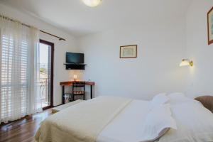 Postel nebo postele na pokoji v ubytování Hotel Vila Tina