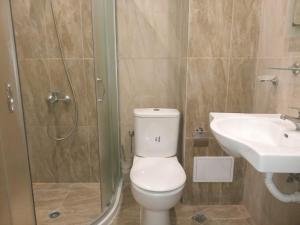 a bathroom with a toilet and a sink and a shower at Festa Studio in Pomorie +11 photos