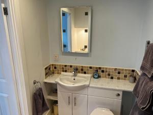 a bathroom with a sink and a mirror and a toilet at Wenden Guest House in Newquay +31 photos
