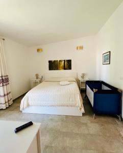 a bedroom with a white bed and a desk at Tra Terra e Mare in Flumini di Quartu +54 photos
