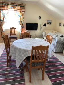 a living room with a table and chairs and a couch at Messlingen 160 in Funäsdalen