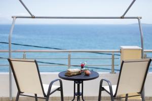 a table with a plate of food on a cruise ship at The Island Life Apartments by Konnect, Ipsos Beach in Ipsos