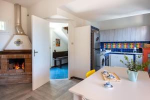 a kitchen and living room with a fireplace at La Casa nell'Oliveto a San Martino in Monreale +14 photos