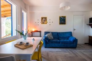 a living room with a blue couch and a table at La Casa nell'Oliveto a San Martino in Monreale