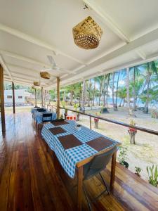 a dining room with a table and a view of the ocean at Mariejoy Haven Beach Resort in San Vicente