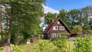 a large house with a red roof at Ferienhaus Spreewald direkt am Wasser in Burg Kauper