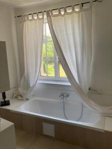 a bath tub in a bathroom with a window at Auern Apartement in Auern