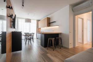 a kitchen and living room with a table and chairs at Palm Beach Jesolo in Lido di Jesolo