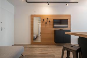a room with a mirror and a bed and a television at Palm Beach Jesolo in Lido di Jesolo