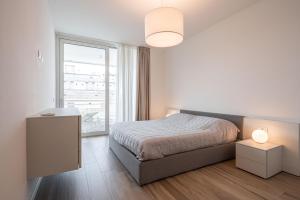 a bedroom with a bed and a large window at Palm Beach Jesolo in Lido di Jesolo +25 photos