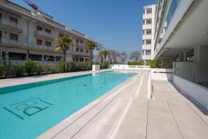 a swimming pool in the middle of a building at Palm Beach Jesolo in Lido di Jesolo