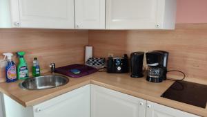 a kitchen counter with a sink and a coffee maker at Ferienwohnung in Rathenow in Rathenow