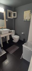 La salle de bains est pourvue de toilettes blanches et d'un lavabo. dans l'établissement Alos, à Amoliani