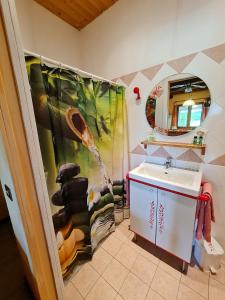 a bathroom with a sink and a shower curtain at Cascina Beneficio in Castelnuovo Bormida