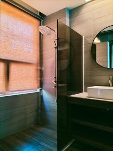 a bathroom with a sink and a mirror at Orange Pearl Beach Resort in El Nido