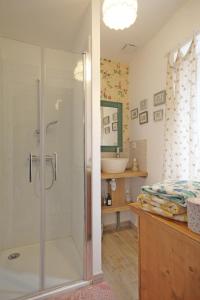 a bathroom with a shower and a sink at Maison Léontine in Bernay