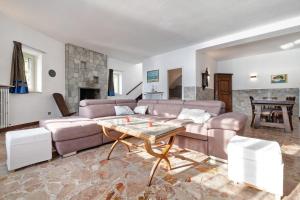 a living room with a couch and a table at Villa Vittoria in Varenna