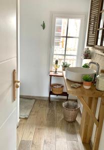 a bathroom with a tub and a sink in a room at Maison Léontine in Bernay