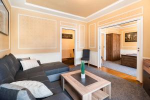 a living room with a couch and a table at City Centre Open View Apartment in Warsaw