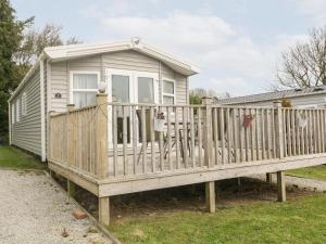 a tiny house with a porch and a deck at Brockenhurst in Redruth