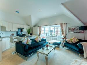 a living room with a couch and a table at Pass the Keys Gorgeous 2 bedroom flat in Penn Hill in Poole