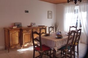 a dining room with a table and chairs and a desk at Maison Saint-Coulomb in Saint-Coulomb +11 photos