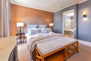 a bedroom with a large bed with two pillows at Deluxe Family Suite 105 in Knysna