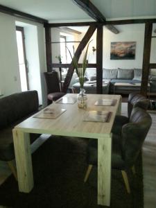 a wooden table and chairs in a living room at Kranichhof in Hohwacht