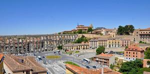 a view of a city with buildings and a street at Hotel ELE Acueducto in Segovia